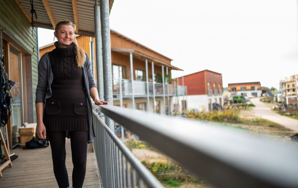 Kathi Schmitz steht an ihrer Wohnung im Hitzacker-Dorf. Etwa 300 Menschen wollen eines Tages in einem Wohnprojekt zusammenleben.